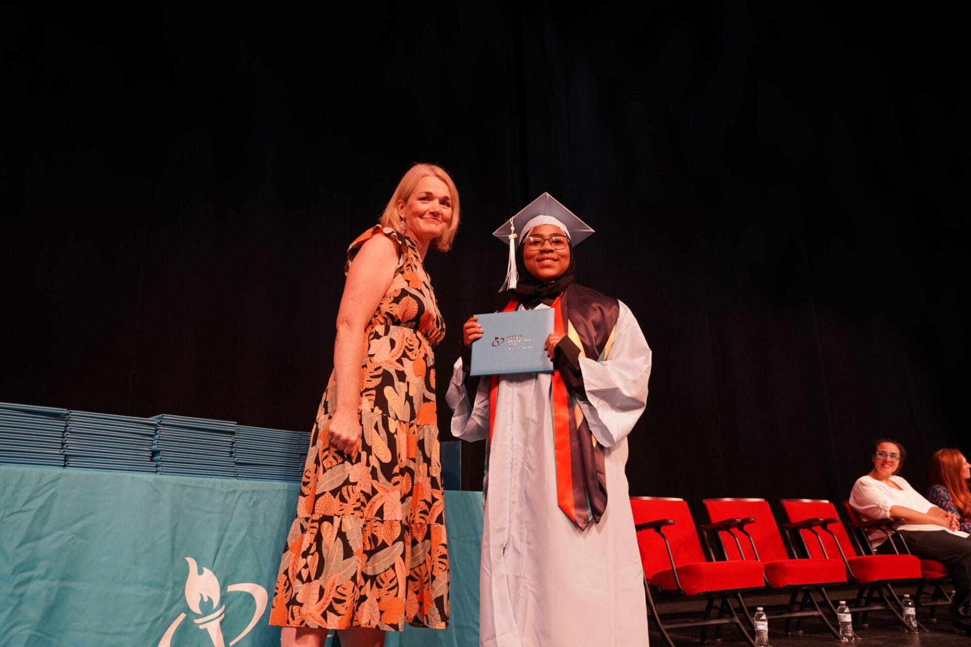director and student with diploma